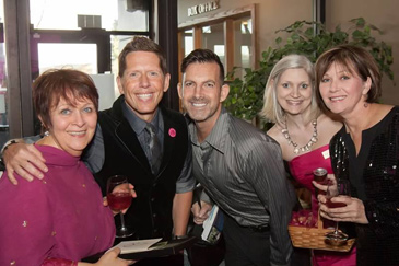 Five people stand together to pose for a photo at the Unleash Your Heart Gala.